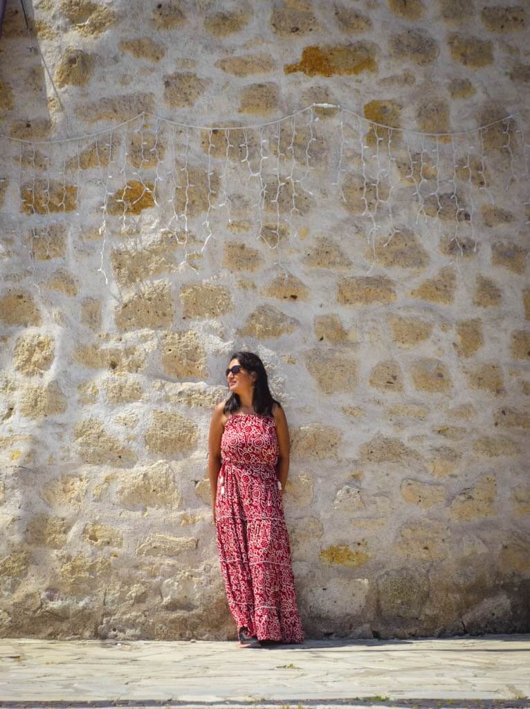 Author leaning against the stone wall of windmill