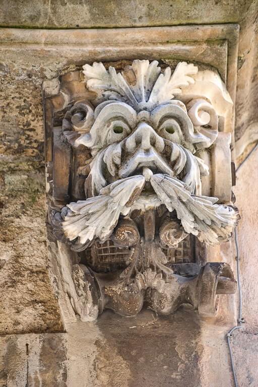 Grotesque mask adorns a balcony in Ragusa