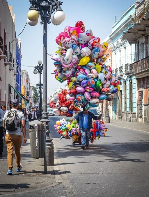 A balloon seller roams the streets of Puebla Historic Center