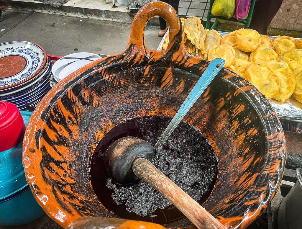 Mole poblano cooked in a traditional terracotta bowl