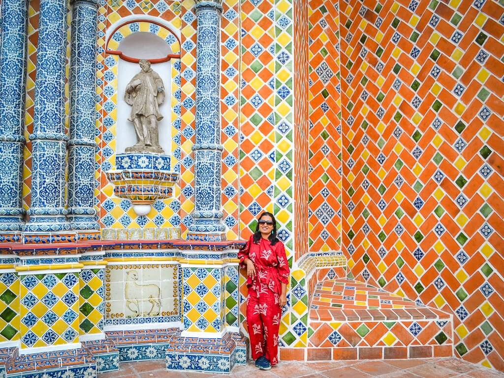 Author at a talavera-covered church in Cholula. These churches are one of the best hidden gems in Mexico.