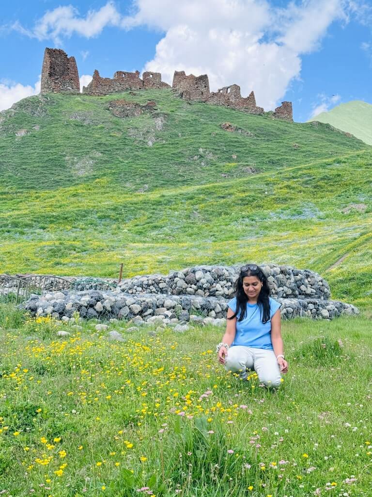 Author in Truso Valley with Zakagori Fortress behind her