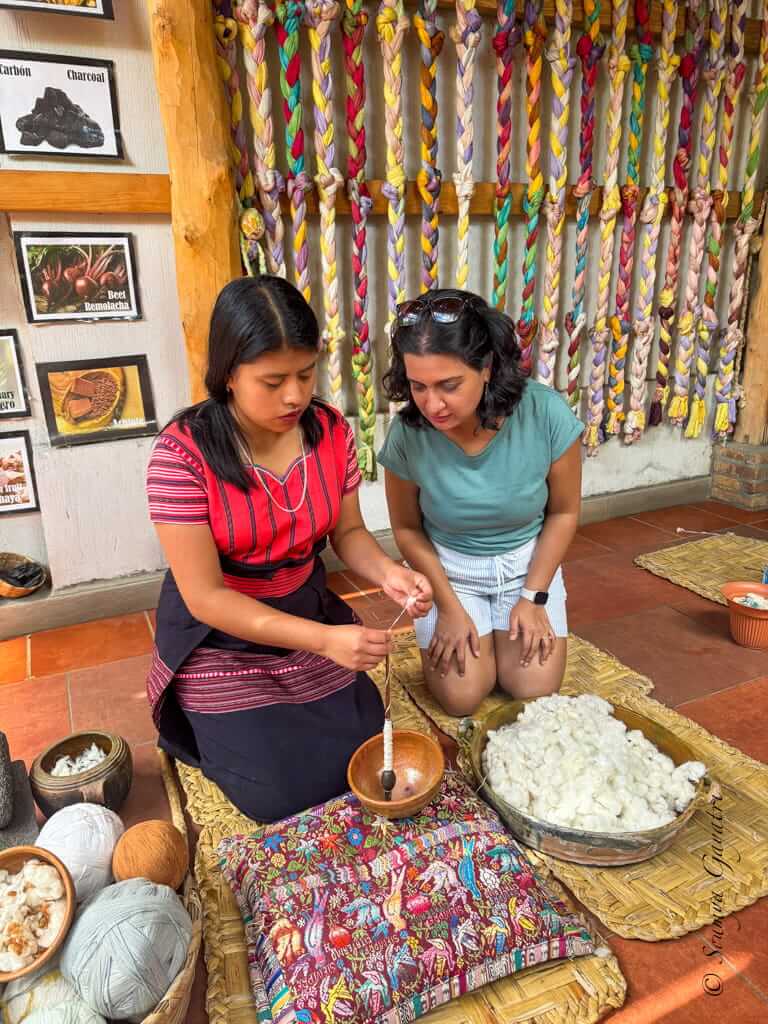 Author learning how to weave from a woman weaver in San Juan La Laguna, Lake Atitlán